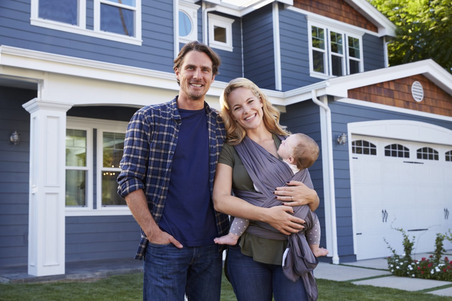 Portrait Of Family Standing Outside House